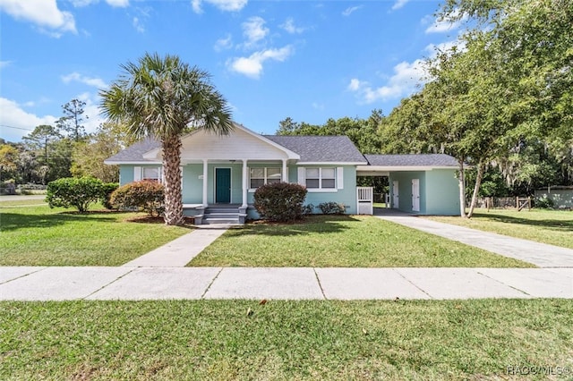 view of front of property with a front lawn and a carport