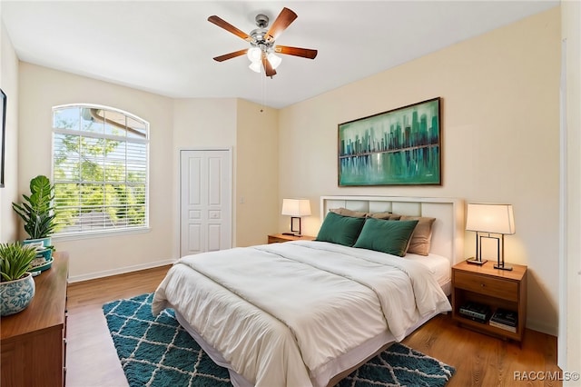 17108 Carrington Park Dr Unit 711, Tampa, FL 33647 - bedroom with a closet, baseboards, a ceiling fan, and wood finished floors