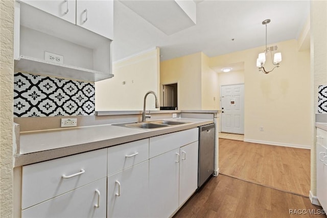 17108 Carrington Park Dr Unit 711, Tampa, FL 33647 - kitchen featuring light countertops, white cabinetry, stainless steel dishwasher, a sink, and wood finished floors