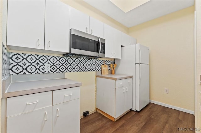 17108 Carrington Park Dr Unit 711, Tampa, FL 33647 - kitchen featuring freestanding refrigerator, dark wood finished floors, stainless steel microwave, light countertops, and decorative backsplash