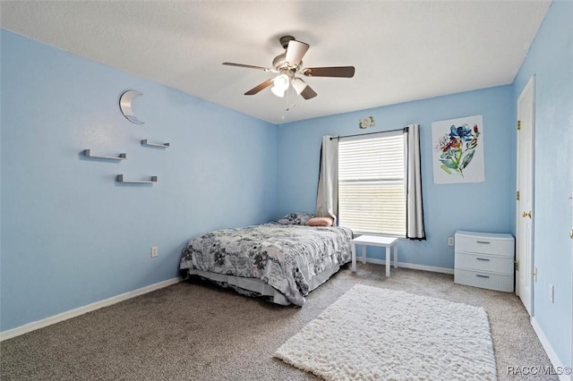 carpeted bedroom with baseboards and ceiling fan
