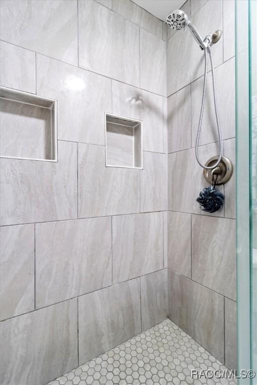 full bath featuring tiled shower