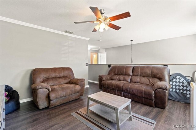 living room with wood finished floors, visible vents, a ceiling fan, and baseboards