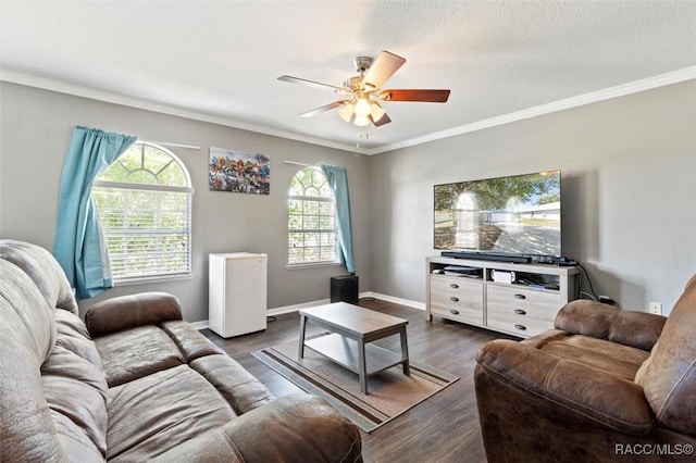 living area featuring dark wood-style flooring, ceiling fan, crown molding, and baseboards