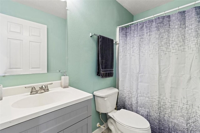 bathroom with toilet, curtained shower, and vanity