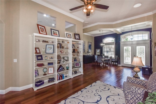 living area featuring french doors, ceiling fan with notable chandelier, dark hardwood / wood-style floors, and ornamental molding