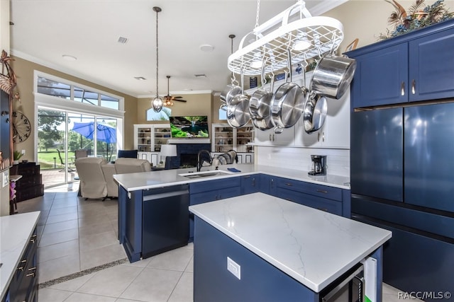 kitchen featuring black dishwasher, a center island, blue cabinets, and sink