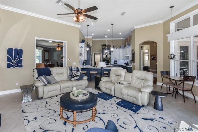 tiled living room featuring ceiling fan and ornamental molding