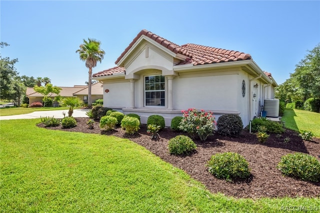 view of property exterior featuring a lawn and central air condition unit