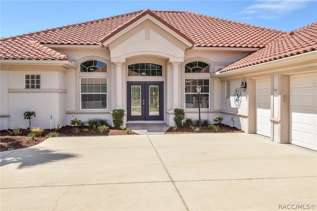 property entrance with french doors and a garage