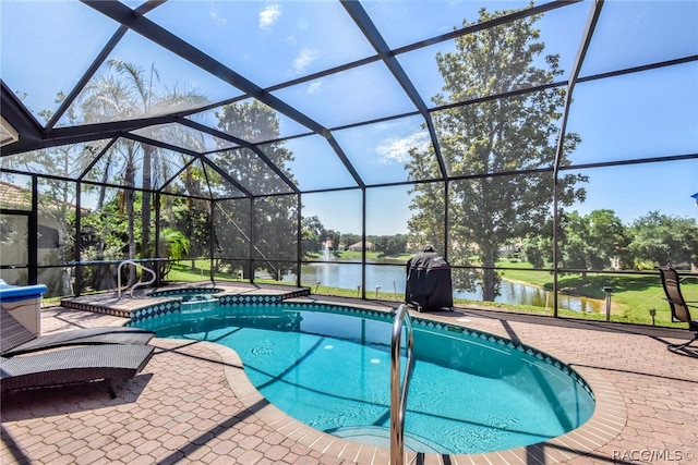 view of pool with a lanai, a patio area, an in ground hot tub, and a water view