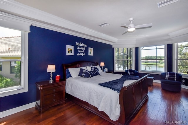 bedroom featuring ceiling fan, dark hardwood / wood-style floors, and ornamental molding