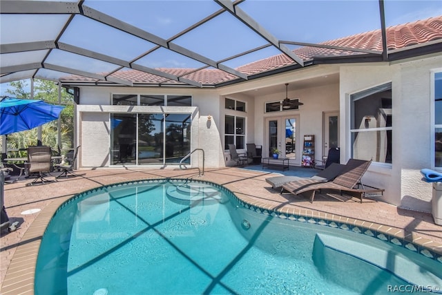 view of swimming pool featuring a patio area, ceiling fan, and a lanai