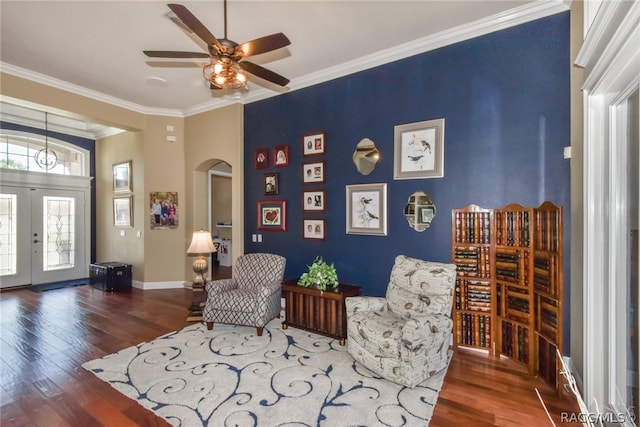 living area with ceiling fan, dark hardwood / wood-style flooring, crown molding, and french doors