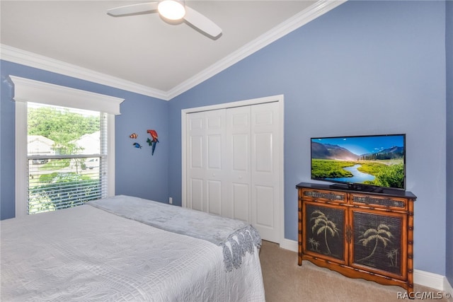 bedroom featuring ceiling fan, light colored carpet, vaulted ceiling, a closet, and ornamental molding