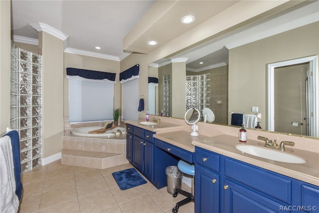 bathroom with tile patterned flooring, vanity, crown molding, and tiled bath