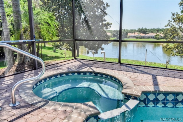 view of swimming pool featuring an in ground hot tub and a water view