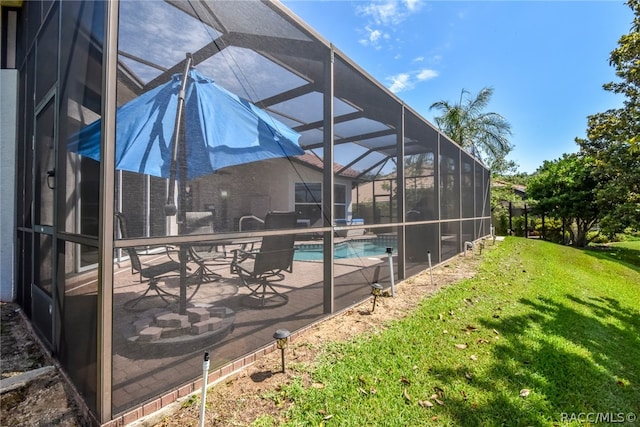 view of swimming pool featuring glass enclosure, a yard, and a patio