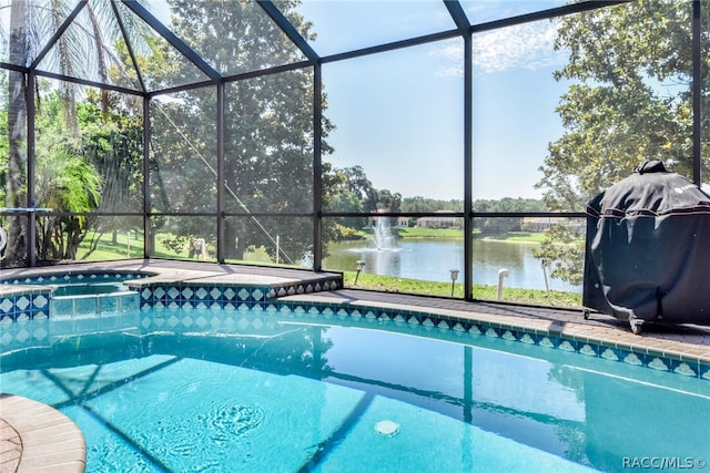 view of swimming pool featuring area for grilling and a water view