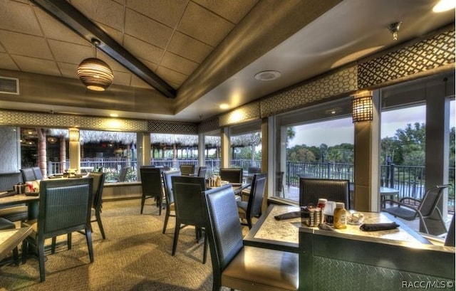 sunroom / solarium featuring plenty of natural light and lofted ceiling