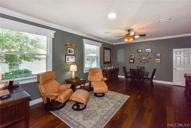 sitting room with dark hardwood / wood-style flooring, a wealth of natural light, and ornamental molding