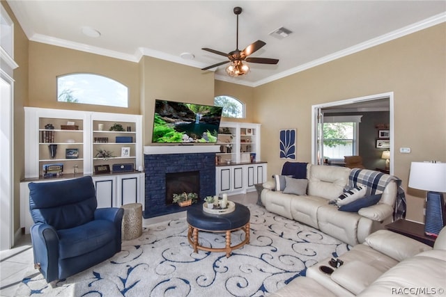 living room featuring a fireplace, ceiling fan, and ornamental molding