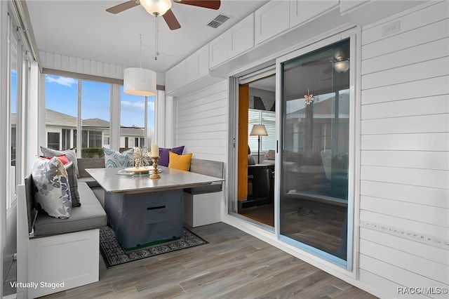 sunroom featuring a wealth of natural light and visible vents