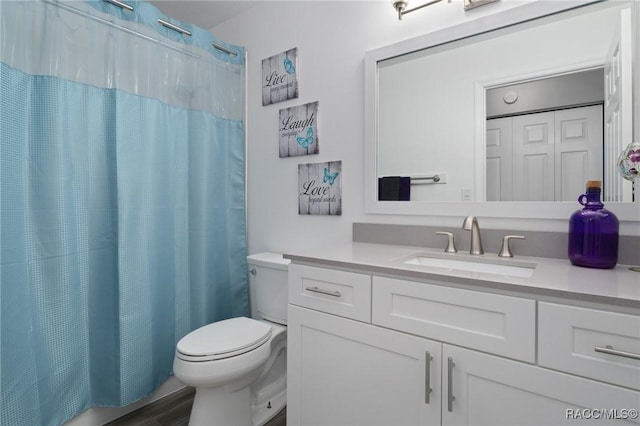 full bathroom featuring vanity, wood finished floors, and toilet