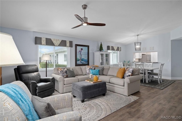 living area featuring ceiling fan, dark wood finished floors, plenty of natural light, and baseboards
