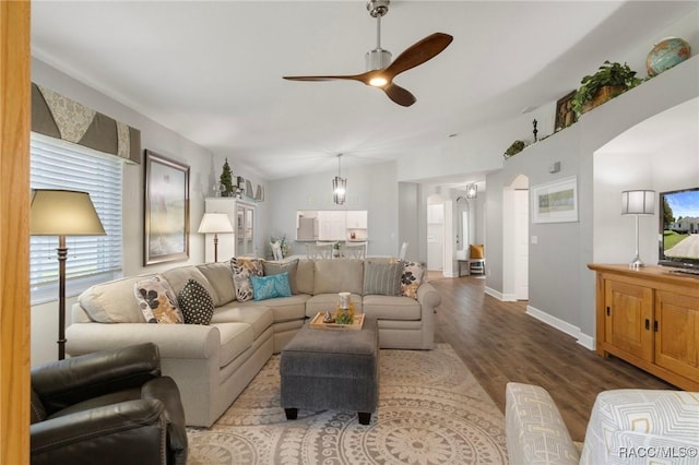 13618 SW 111th Cir, Dunnellon, FL 34432 - living room featuring arched walkways, a ceiling fan, wood finished floors, and baseboards