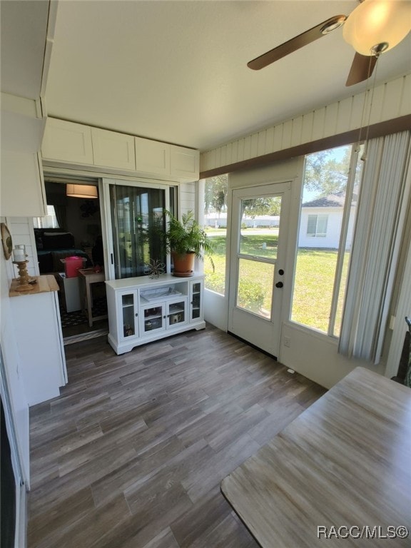 unfurnished sunroom with a wealth of natural light, french doors, and a ceiling fan