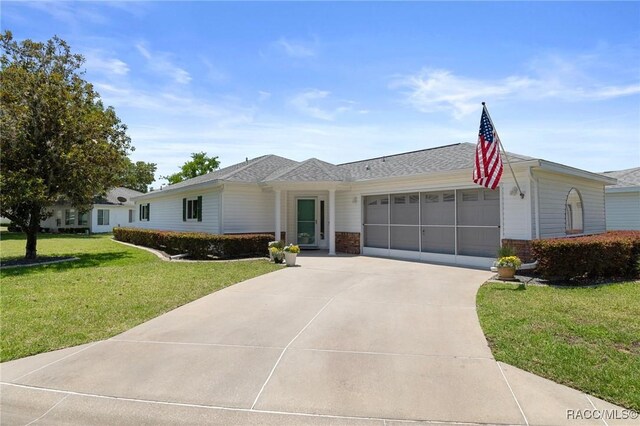 13618 SW 111th Cir, Dunnellon, FL 34432 - ranch-style house with an attached garage, concrete driveway, a front yard, and brick siding
