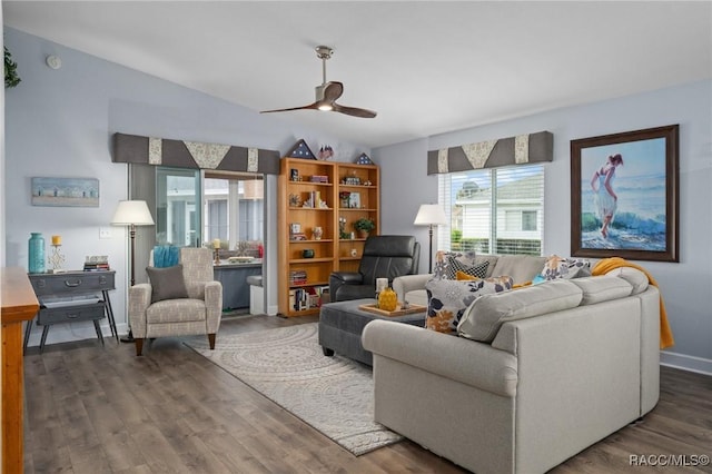 living area with a ceiling fan, wood finished floors, and lofted ceiling