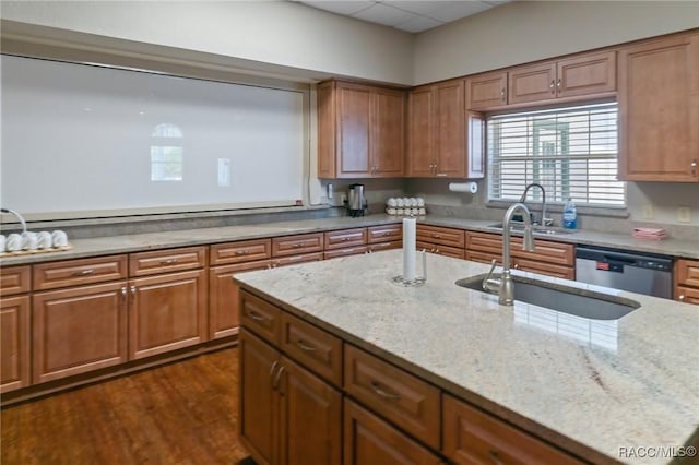 13618 SW 111th Cir, Dunnellon, FL 34432 - kitchen with a sink, dishwasher, brown cabinets, and light stone countertops