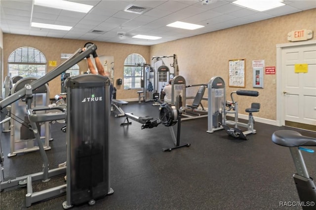 13618 SW 111th Cir, Dunnellon, FL 34432 - exercise room with a paneled ceiling, healthy amount of natural light, and baseboards
