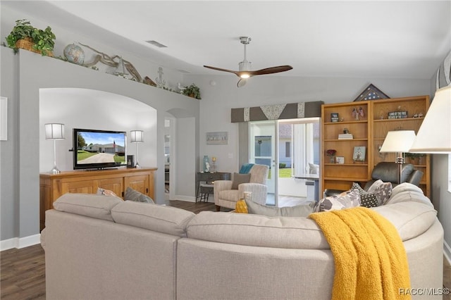 13618 SW 111th Cir, Dunnellon, FL 34432 - living area featuring dark wood finished floors, a ceiling fan, arched walkways, baseboards, and vaulted ceiling
