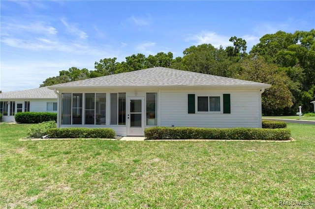 13618 SW 111th Cir, Dunnellon, FL 34432 - back of property with a lawn and a sunroom