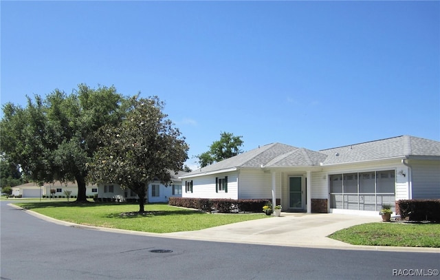 ranch-style house with a front lawn, driveway, and an attached garage