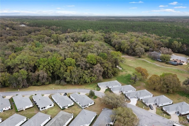 drone / aerial view with a residential view and a wooded view