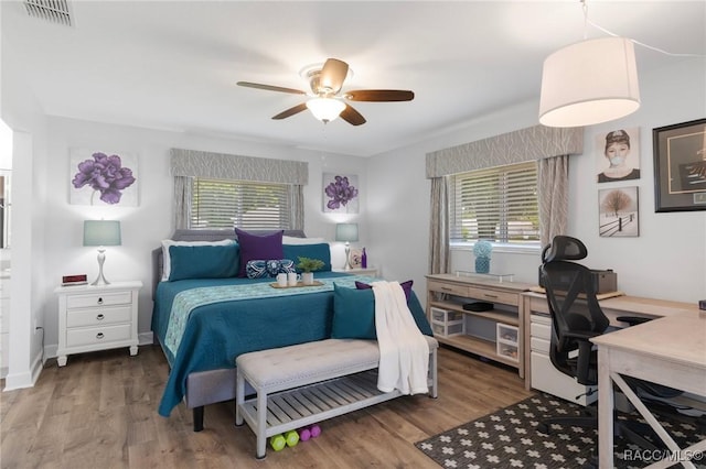 13618 SW 111th Cir, Dunnellon, FL 34432 - bedroom with an office area, wood finished floors, and ceiling fan