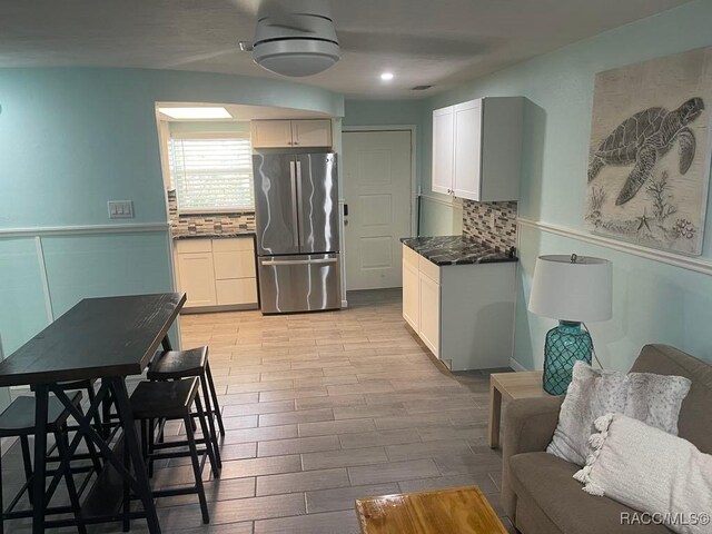 1412 SE Paradise Ave Unit 2, Crystal River, FL 34429 - back of property featuring a sunroom, a lawn, roof with shingles, and a patio