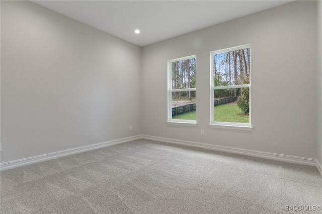 spare room with recessed lighting, baseboards, and carpet