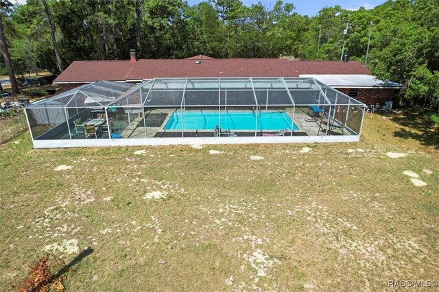 pool featuring a yard, a patio area, and a lanai