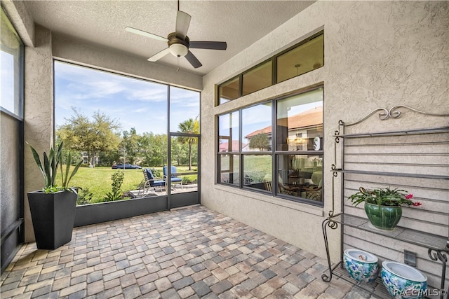 sunroom featuring ceiling fan