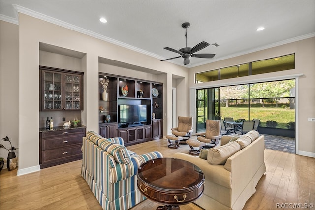 living room featuring light wood-type flooring, ceiling fan, and ornamental molding