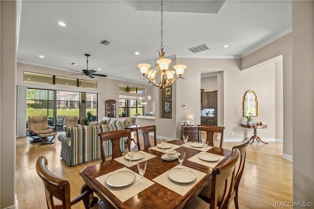 dining space with crown molding, light hardwood / wood-style flooring, and ceiling fan with notable chandelier