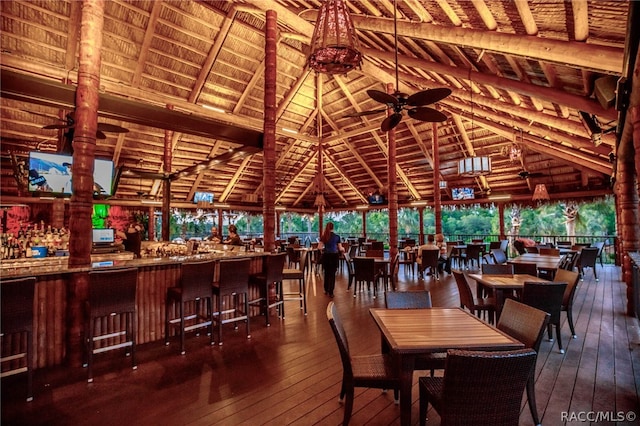 dining space featuring wood ceiling, vaulted ceiling with beams, ceiling fan, and dark wood-type flooring