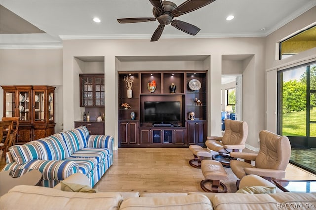 living room with light hardwood / wood-style flooring, ceiling fan, and ornamental molding