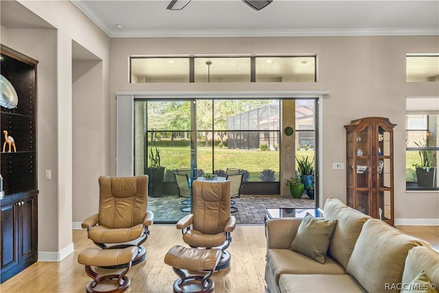 living room with light hardwood / wood-style floors and ornamental molding