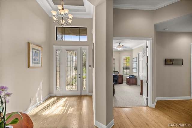 foyer featuring light wood-type flooring and crown molding